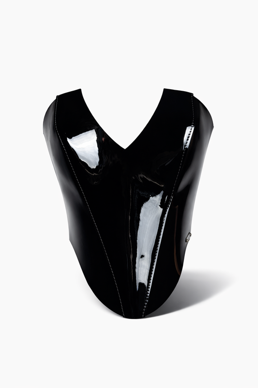 Black patent leather corset on a white background