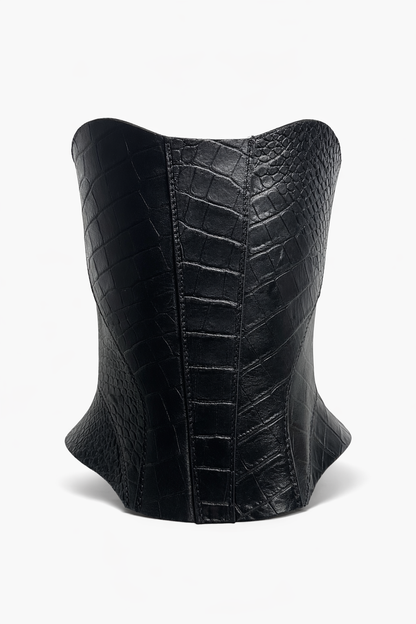 Black leather corset with a textured pattern on a white background
